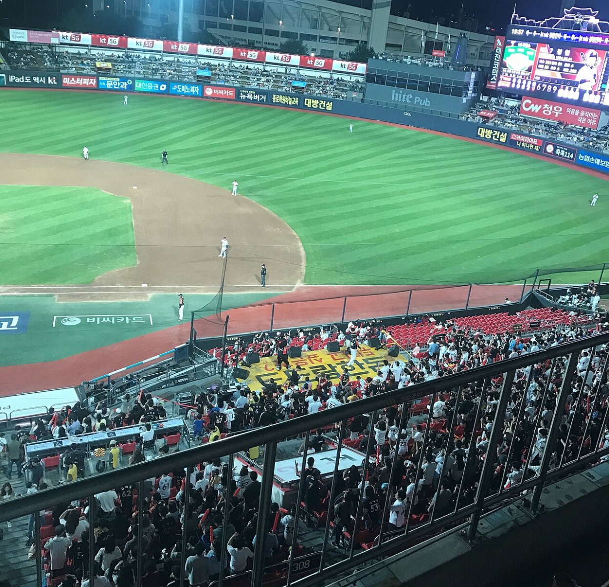 Fans cheering in the stands at a Korean professional baseball game in Suwon