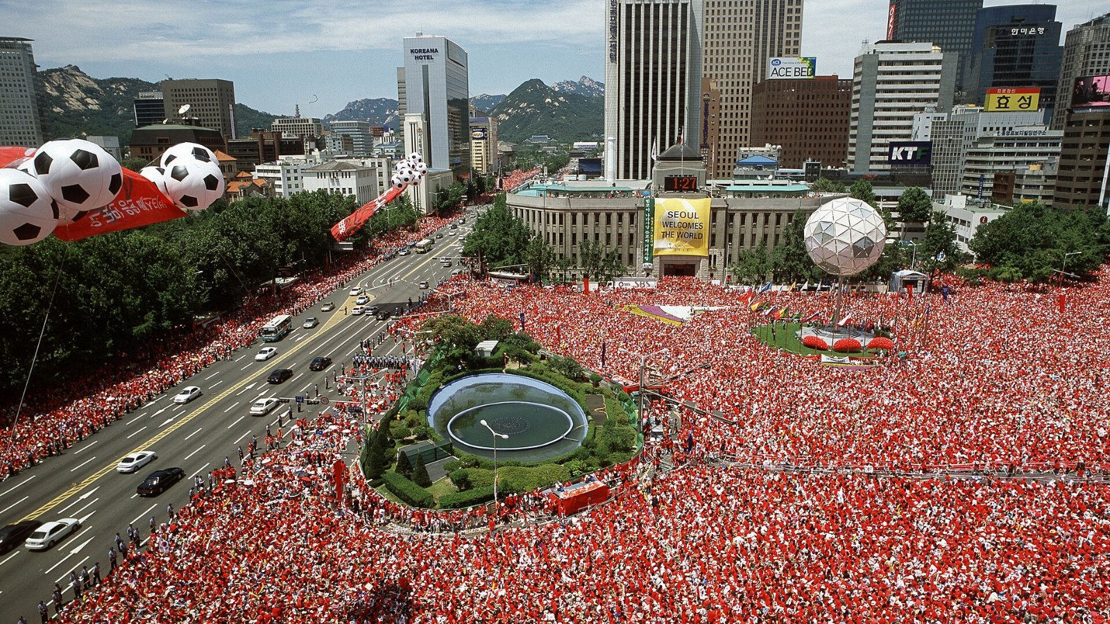 Crowds dressed in red filling Seoul Plaza to cheer for Korea during the 2002 FIFA World Cup